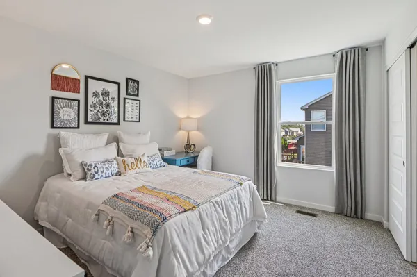 a bedroom with a bed and a window