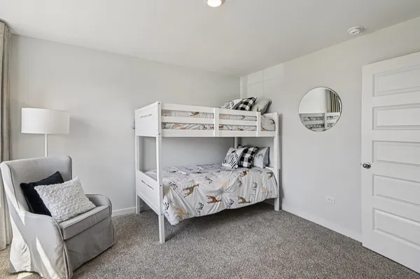 a bedroom with bed and white cabinet