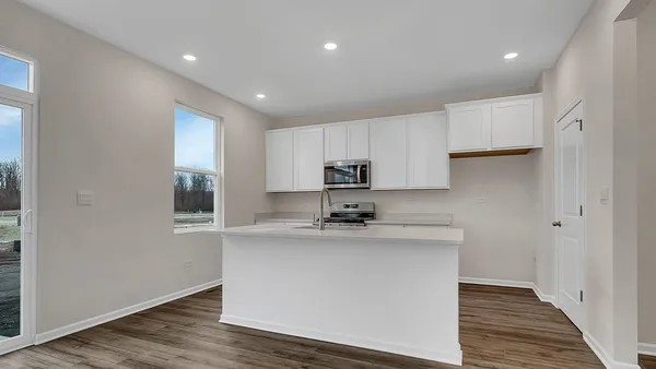 a kitchen with stainless steel appliances granite countertop a sink a stove and a refrigerator