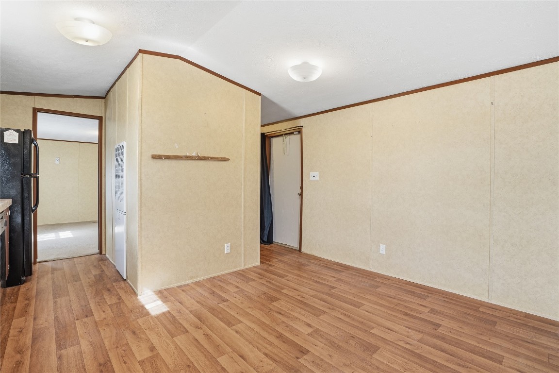 801 Genoa Red Bluff Road Pasadena, TX 77504 - Photo 11 of 33 a view of an empty room with wooden floor and a window