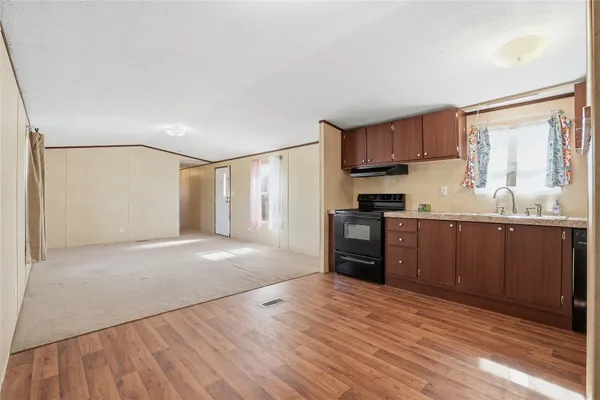 a kitchen with stainless steel appliances granite countertop a refrigerator sink and cabinets