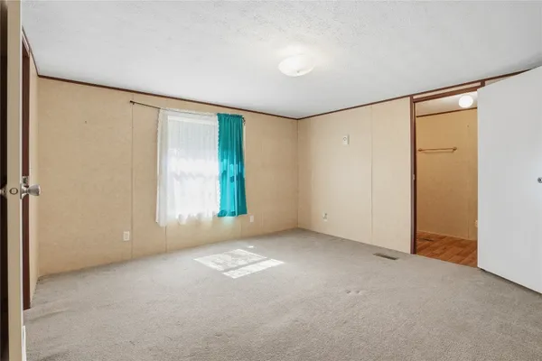 a view of an empty room with a window