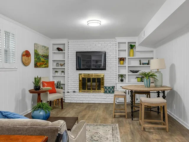 a living room with furniture and a fireplace