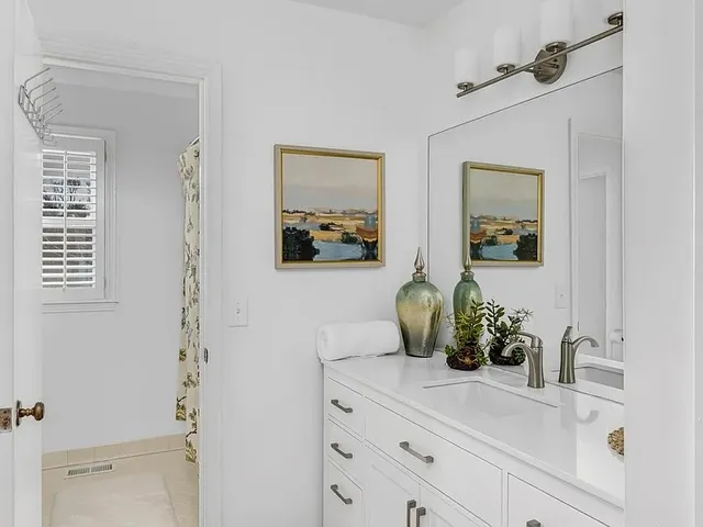 a bathroom with a sink and mirror
