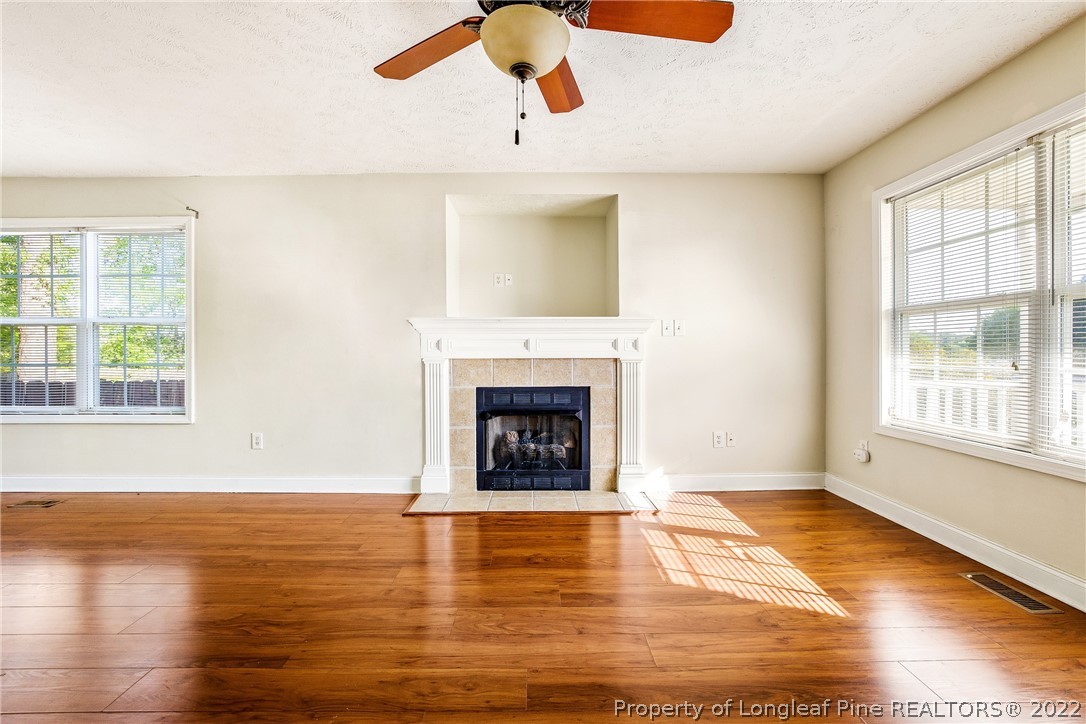 1631 Silver Ridge Court Fayetteville, NC 28304 - Photo 12 of 21 a view of an empty room with wooden floor fireplace and a window