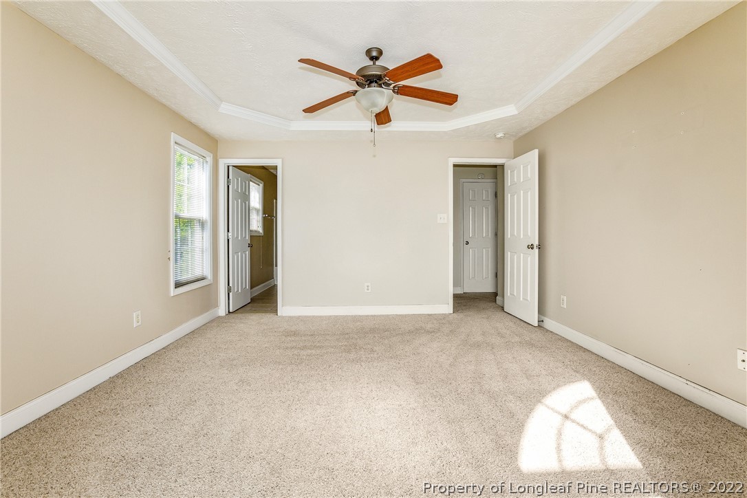 1631 Silver Ridge Court Fayetteville, NC 28304 - Photo 19 of 21 an empty room with closet and ceiling fan