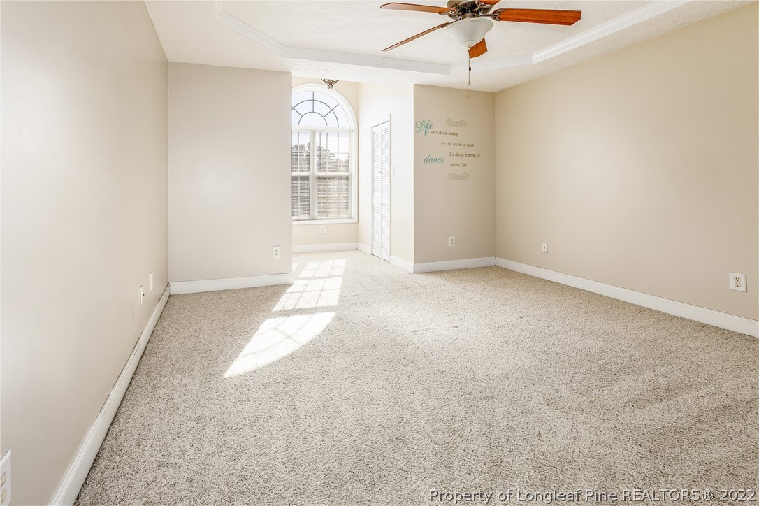 1631 Silver Ridge Court Fayetteville, NC 28304 - Photo 20 of 21 an empty room with windows and ceiling fan