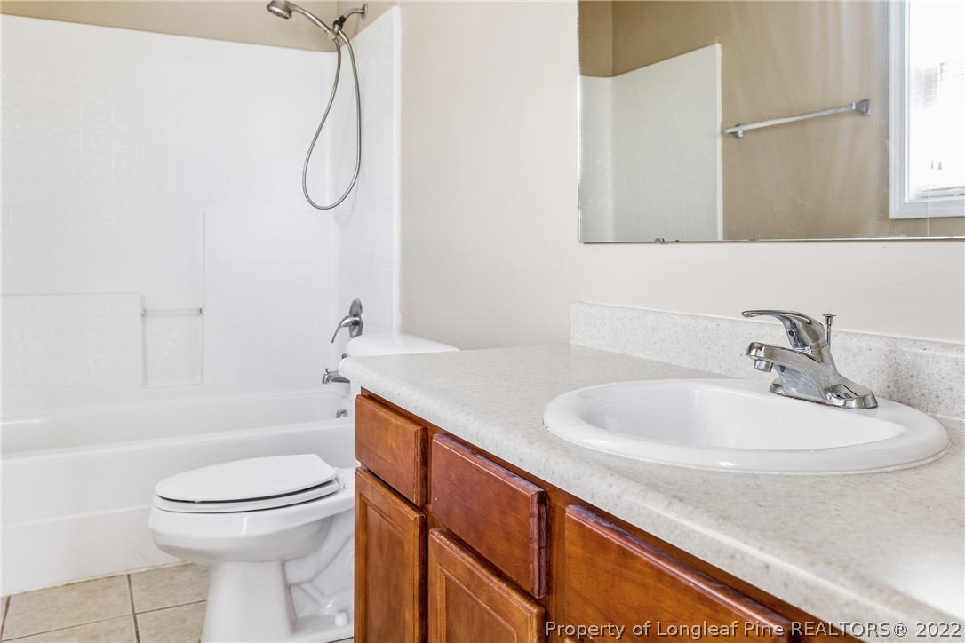 1631 Silver Ridge Court Fayetteville, NC 28304 - Photo 21 of 21 a bathroom with a sink a toilet and shower