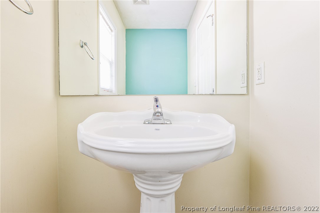 1631 Silver Ridge Court Fayetteville, NC 28304 - Photo 9 of 21 a bathroom with a sink and a mirror