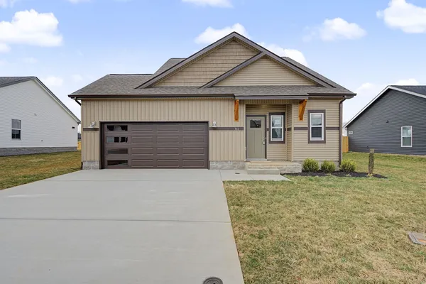 a front view of a house with a yard and garage