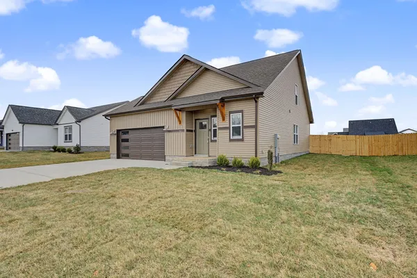 a view of a house with a yard and garage
