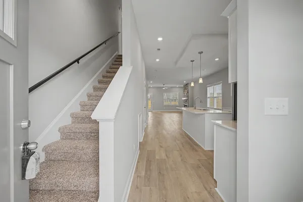 a view of entryway and hall with wooden floor