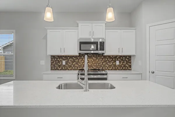 a kitchen with a sink and a microwave