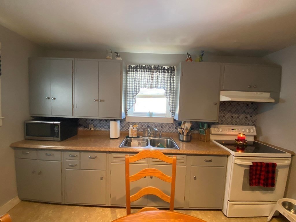 62 Lenox Circle Athol, MA 01331 - Photo 3 of 13 a kitchen with stainless steel appliances granite countertop a sink stove and cabinets