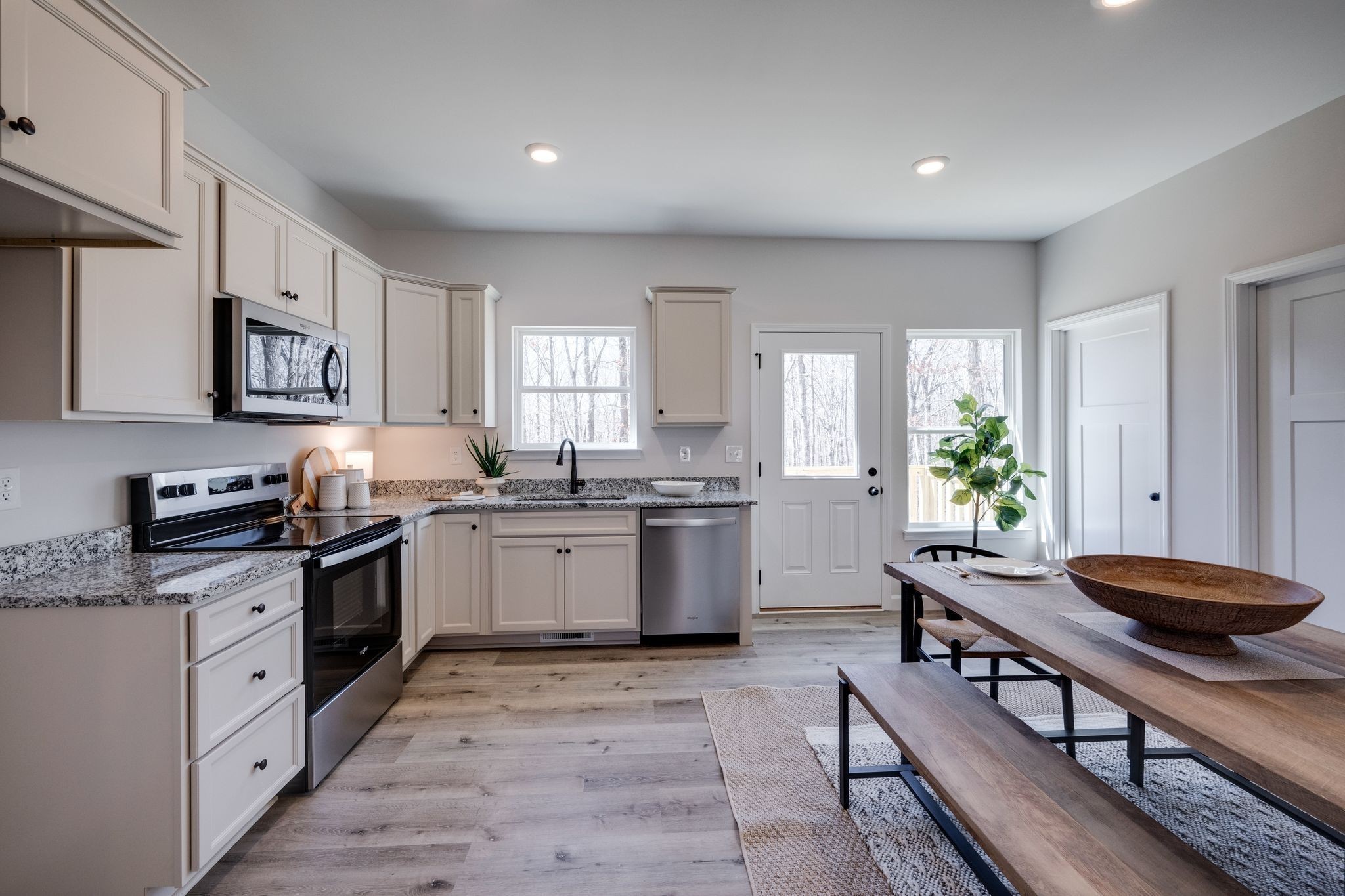 762 Billy Wynn Road Dickson, TN 37055 - Photo 14 of 38 a kitchen with stainless steel appliances kitchen island granite countertop a sink counter space cabinets and a window