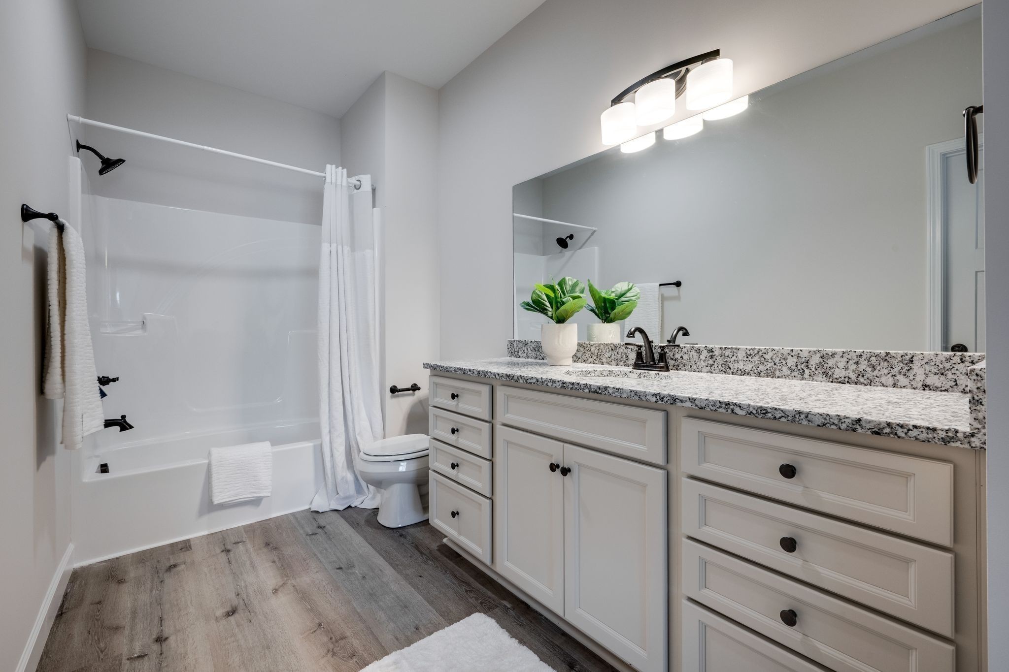 762 Billy Wynn Road Dickson, TN 37055 - Photo 24 of 38 a spacious bathroom with a granite countertop sink a toilet and a mirror