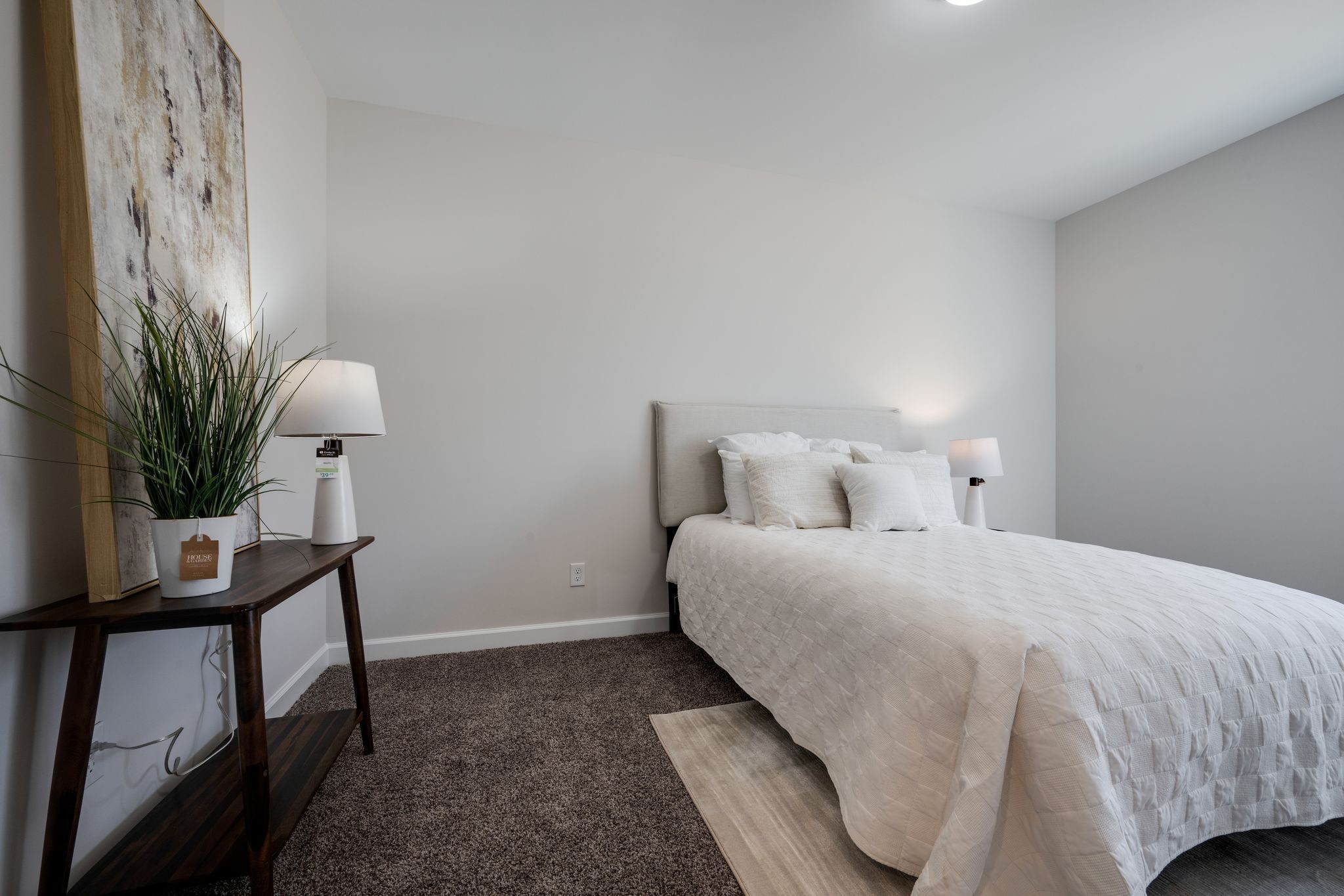 762 Billy Wynn Road Dickson, TN 37055 - Photo 28 of 38 a bedroom with a bed table chair and a potted plant