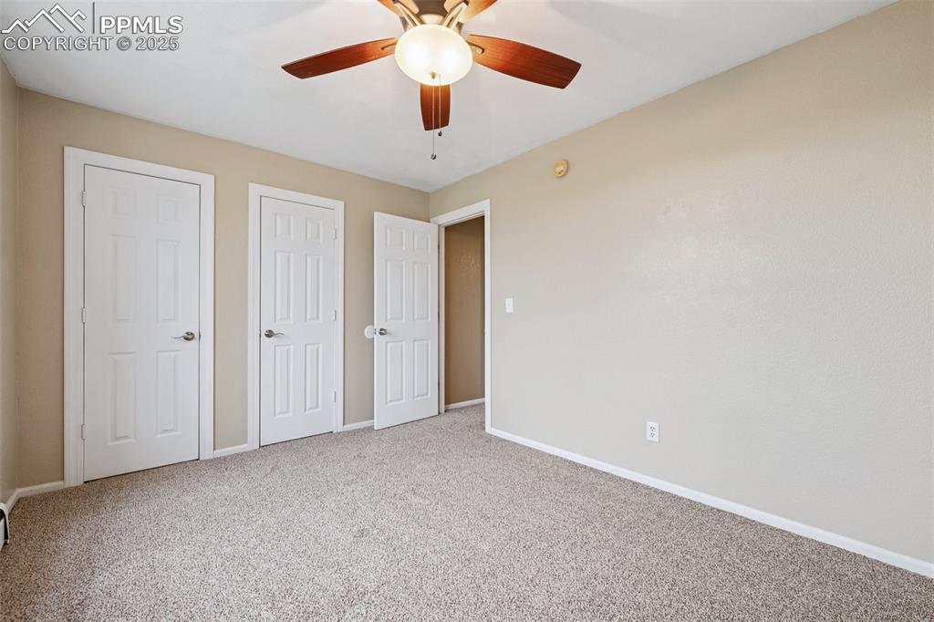 13490 Halleluiah Trail Elbert, CO 80106 - Photo 12 of 38 an empty room with a ceiling fan and a ceiling fan