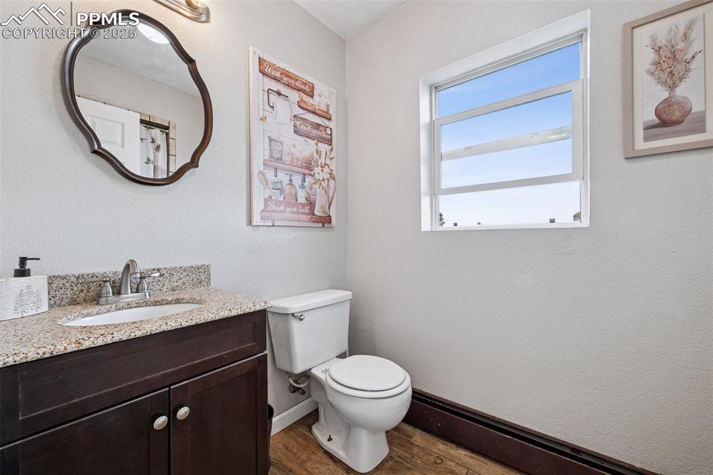 13490 Halleluiah Trail Elbert, CO 80106 - Photo 23 of 38 a bathroom with a toilet a sink and a mirror