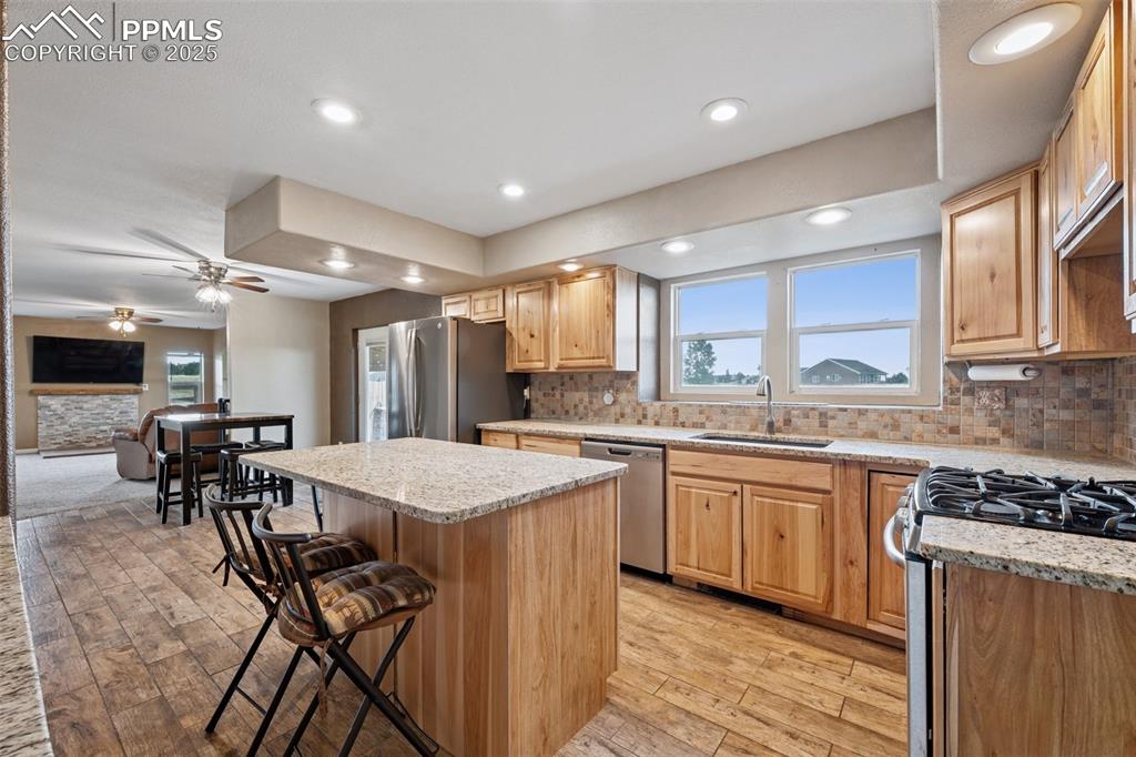 13490 Halleluiah Trail Elbert, CO 80106 - Photo 5 of 38 a kitchen with stainless steel appliances granite countertop sink stove top oven and cabinets