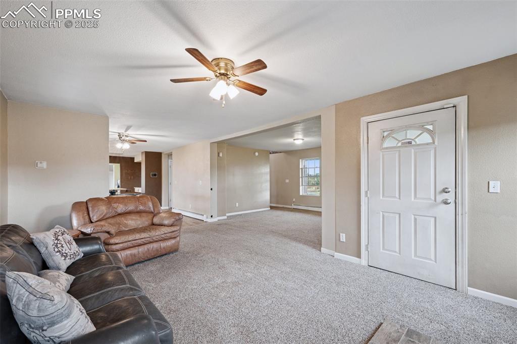 13490 Halleluiah Trail Elbert, CO 80106 - Photo 9 of 38 a living room with furniture and a ceiling fan
