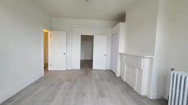 a view of a hallway with wooden floor