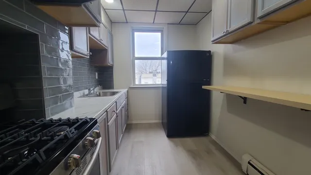 a kitchen with a stove and a refrigerator