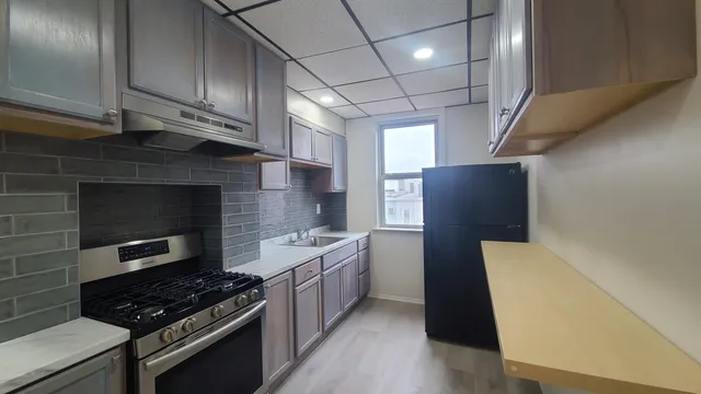 a kitchen with cabinets a sink and a stove top oven