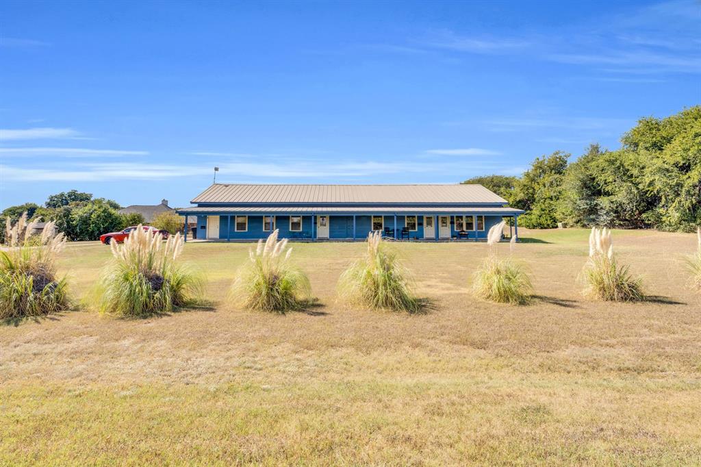 3841 Ledgestone Lane Midlothian, TX 76065 - Photo 5 of 21 View of front of home featuring a front lawn, a metal roof, and covered porch