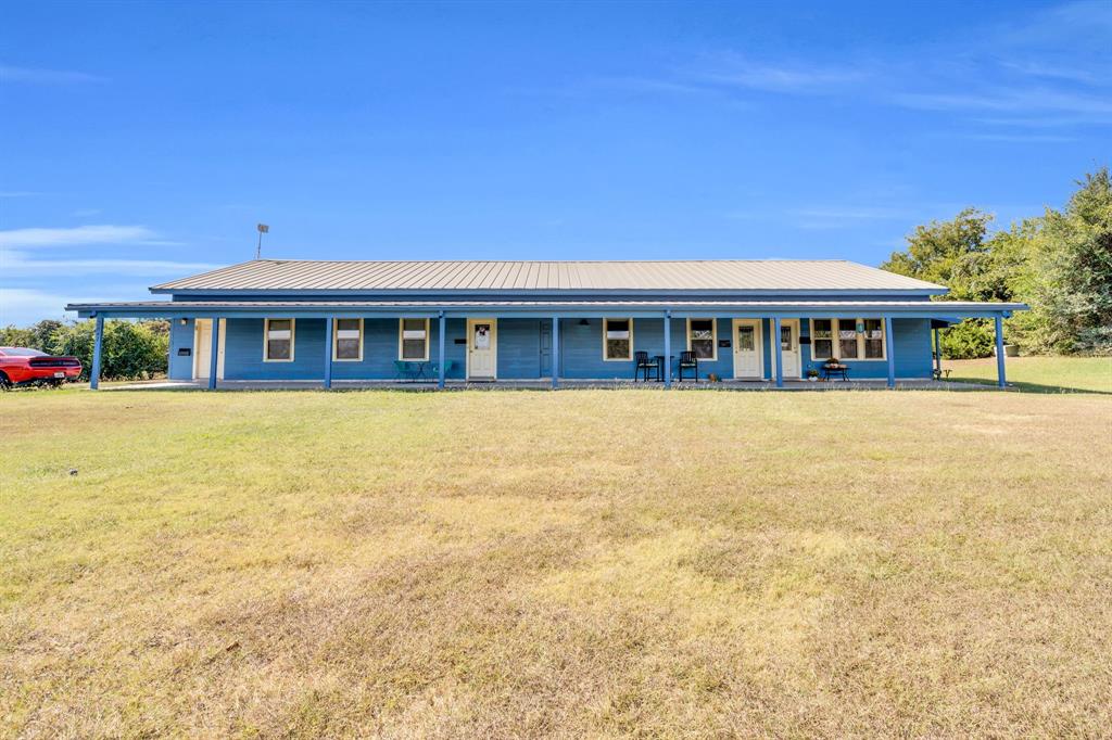 3841 Ledgestone Lane Midlothian, TX 76065 - Photo 4 of 21 Country-style home featuring covered porch, a front lawn, and a metal roof