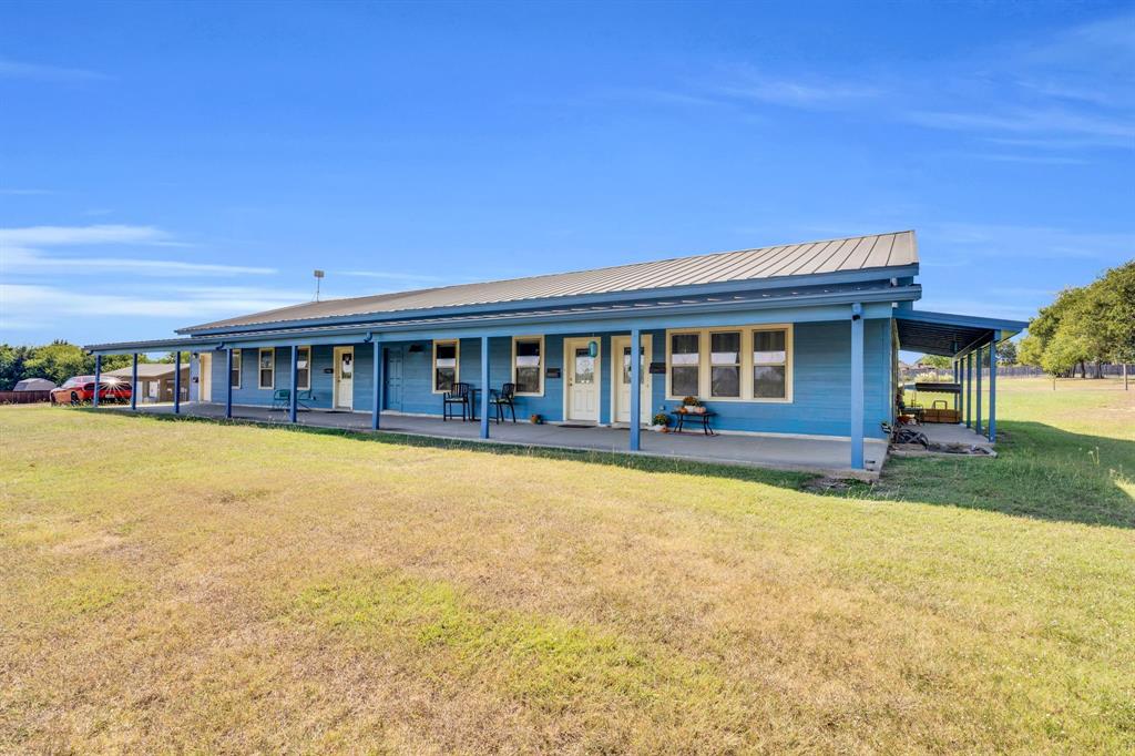 3841 Ledgestone Lane Midlothian, TX 76065 - Photo 5 of 21 Farmhouse featuring a front lawn, a metal roof, and covered porch