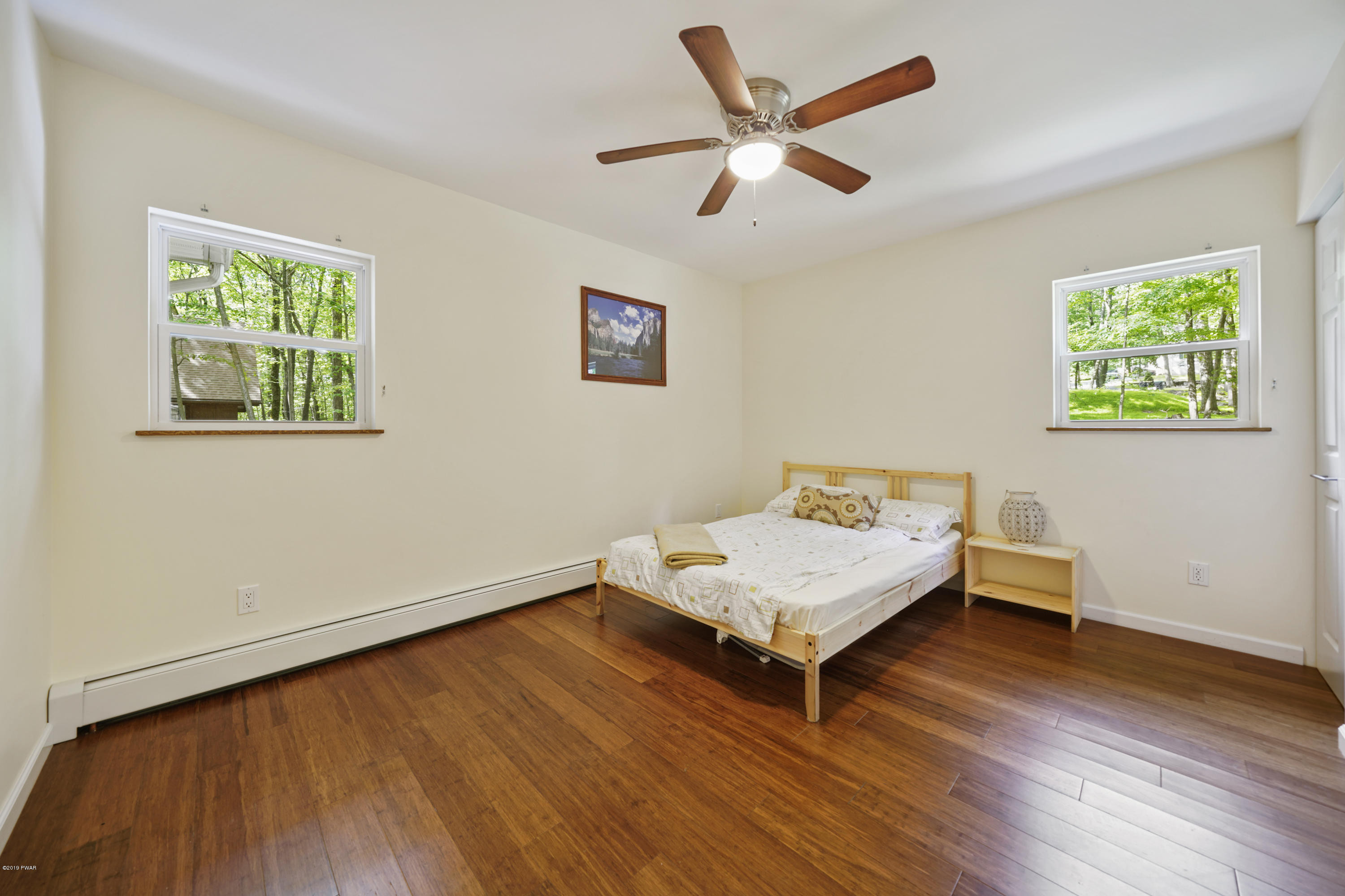 176 Gold Key Road Milford, PA 18337 - Photo 20 of 27 a living room with hard wood floors and a ceiling fan