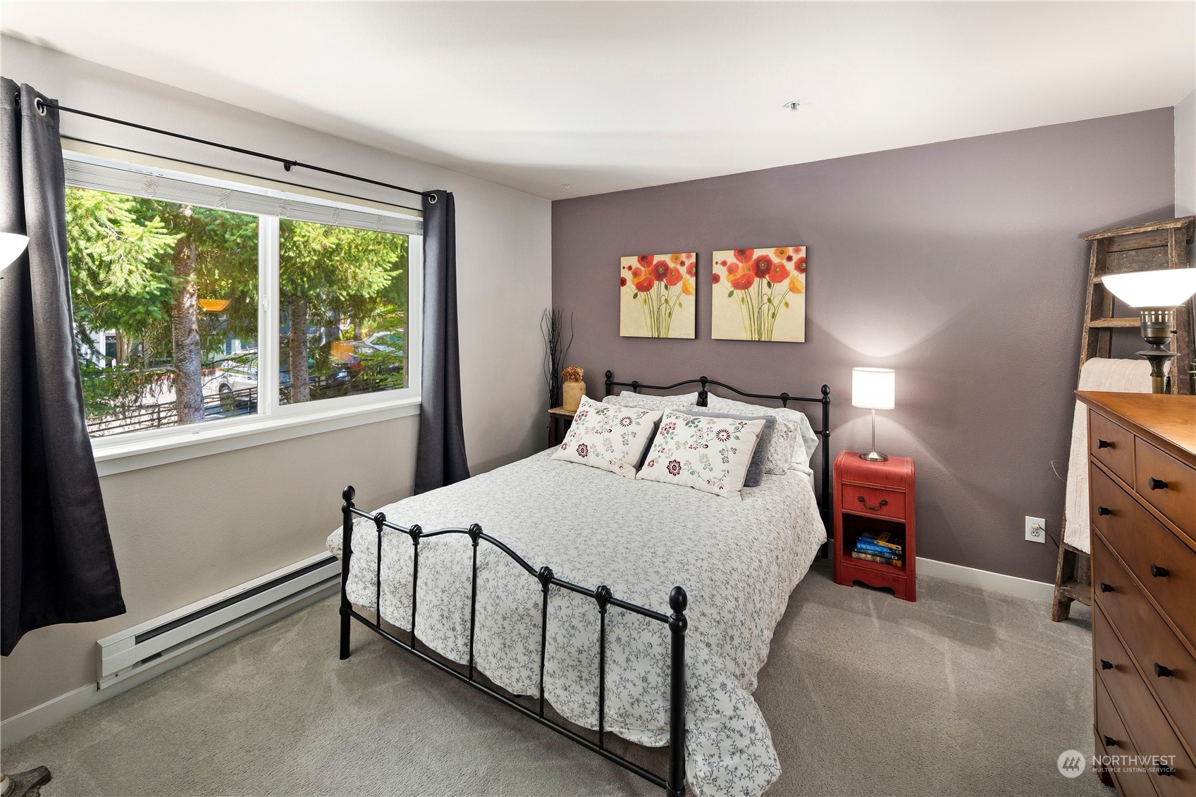 3914 243rd Place Southeast, Unit L401 Bothell, WA 98021 - Photo 17 of 25 a bedroom with a bed and a flat tv screen on dresser