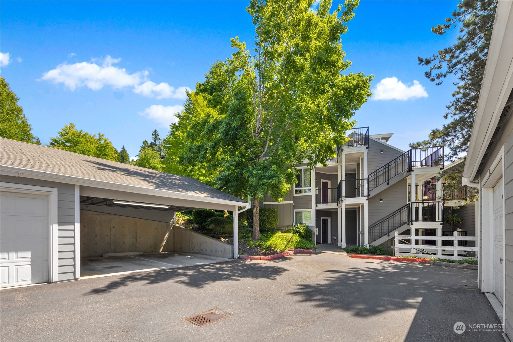 3914 243rd Place Southeast, Unit L401 Bothell, WA 98021 - Photo 20 of 25 a view of a house with backyard and a garage