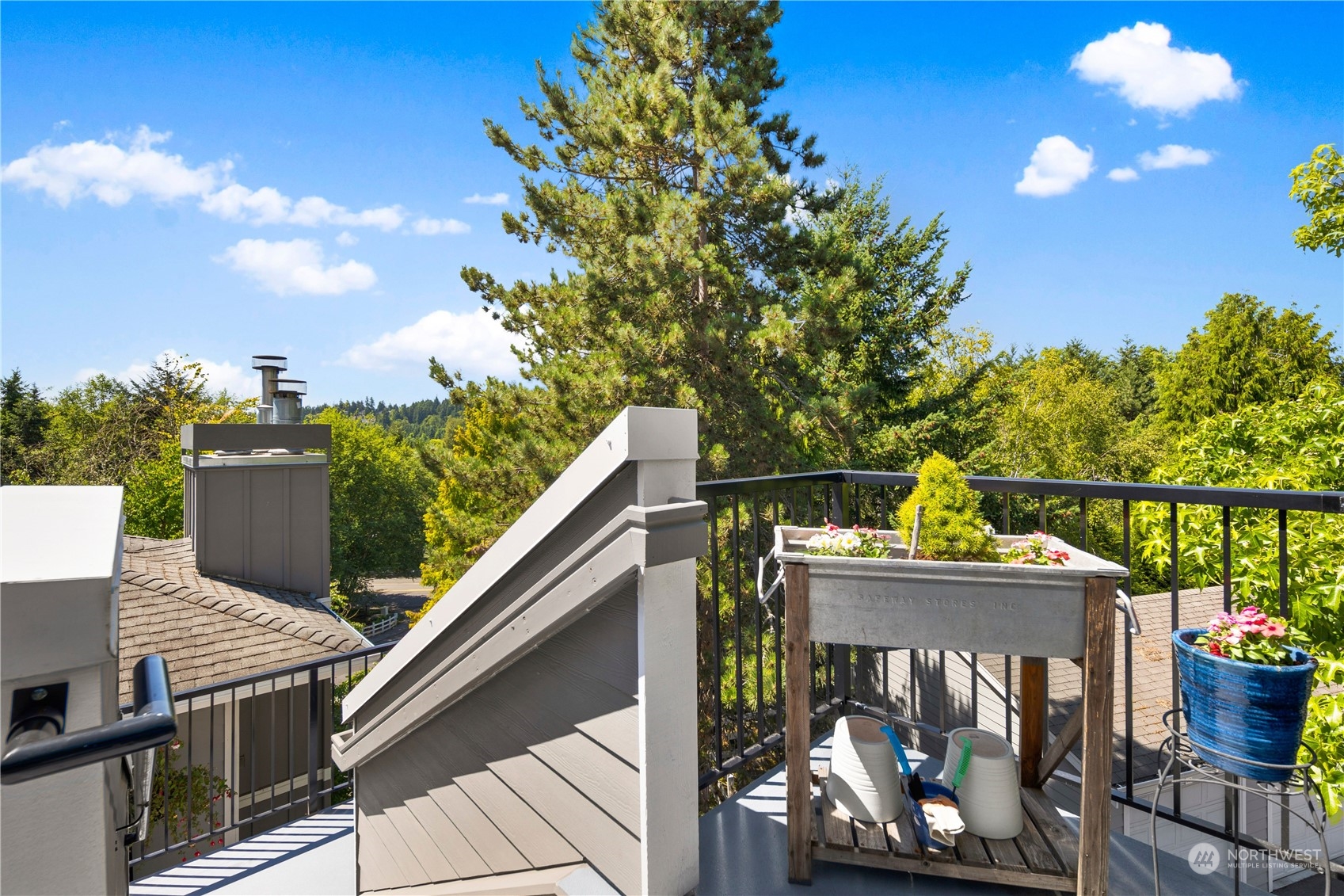 3914 243rd Place Southeast, Unit L401 Bothell, WA 98021 - Photo 21 of 25 a view of a balcony with two chairs and a potted plant