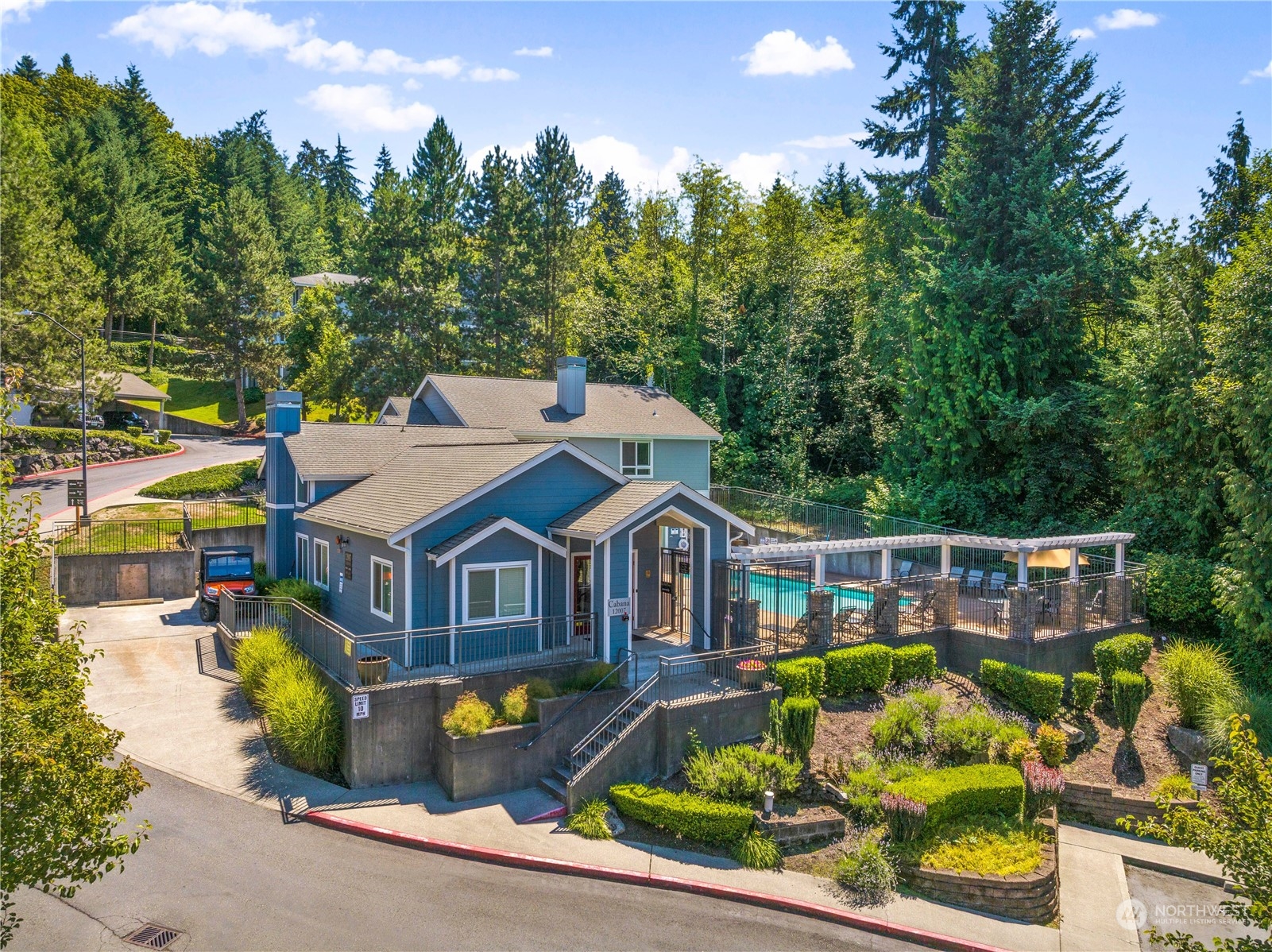 3914 243rd Place Southeast, Unit L401 Bothell, WA 98021 - Photo 24 of 25 an aerial view of a house with swimming pool and large trees