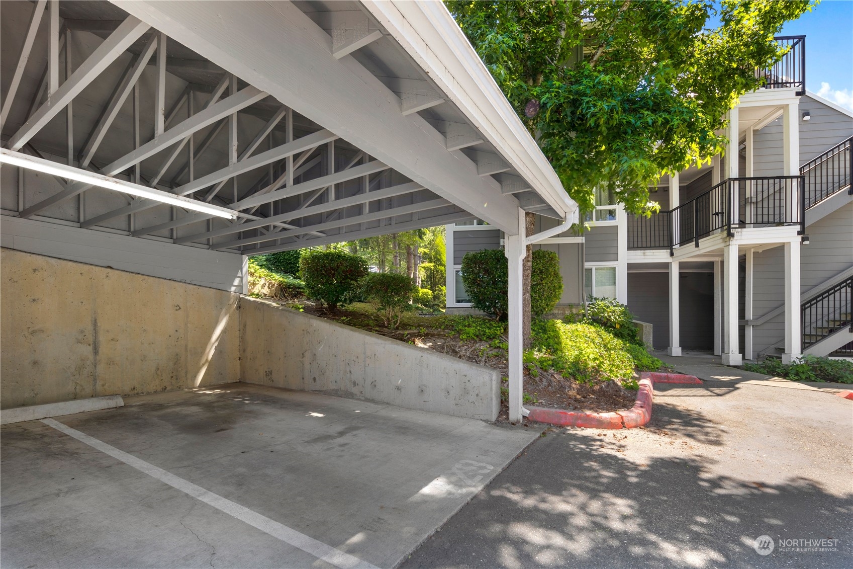 3914 243rd Place Southeast, Unit L401 Bothell, WA 98021 - Photo 25 of 25 a view of a patio with table and chairs a barbeque