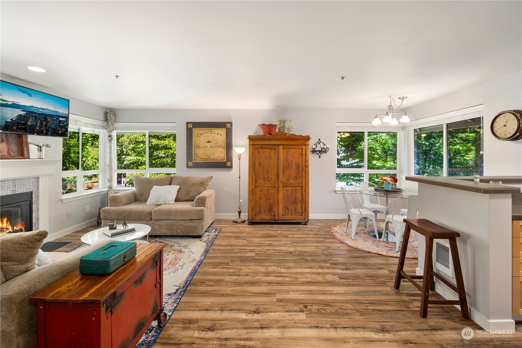 3914 243rd Place Southeast, Unit L401 Bothell, WA 98021 - Photo 8 of 25 a living room with furniture a large window and a fireplace
