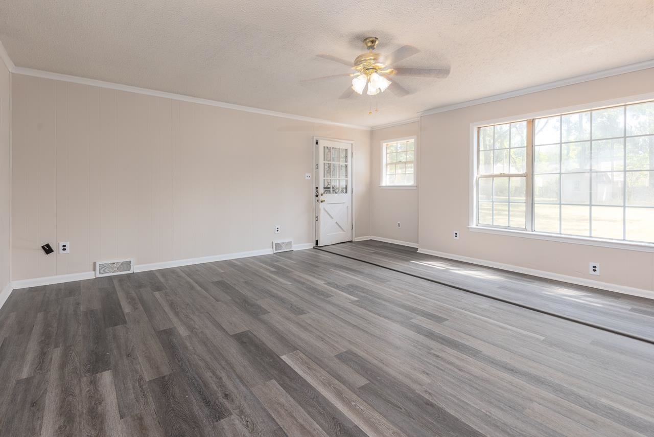 2718 Kate Bond Road Memphis, TN 38133 - Photo 5 of 39 Spare room featuring ornamental molding, a ceiling fan, wood finished floors, and a textured ceiling