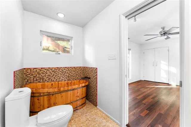 a bathroom with a toilet and a shower