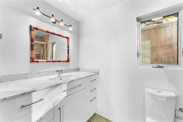 a bathroom with a sink vanity and a mirror