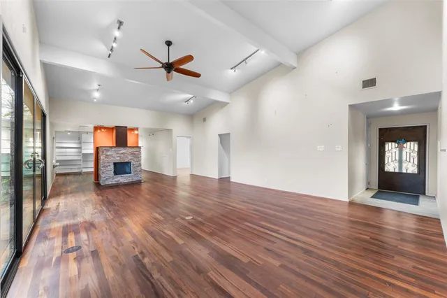 wooden floor in an empty room with a window