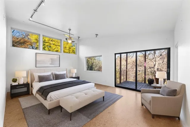 a bedroom with a bed and glass window