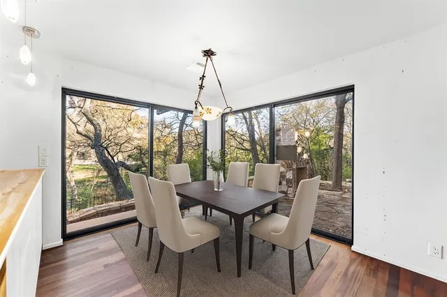 a dining room with furniture window and wooden floor