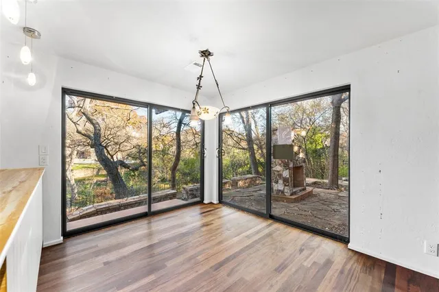 a view of a room with wooden floor and doors