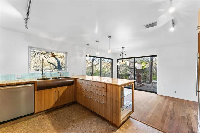 a view of a kitchen with large windows
