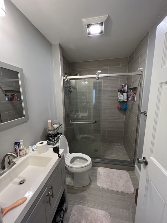 209 East Cottage Street, Unit 1 Boston, MA 02125 - Photo 5 of 10 a bathroom with a sink toilet and shower