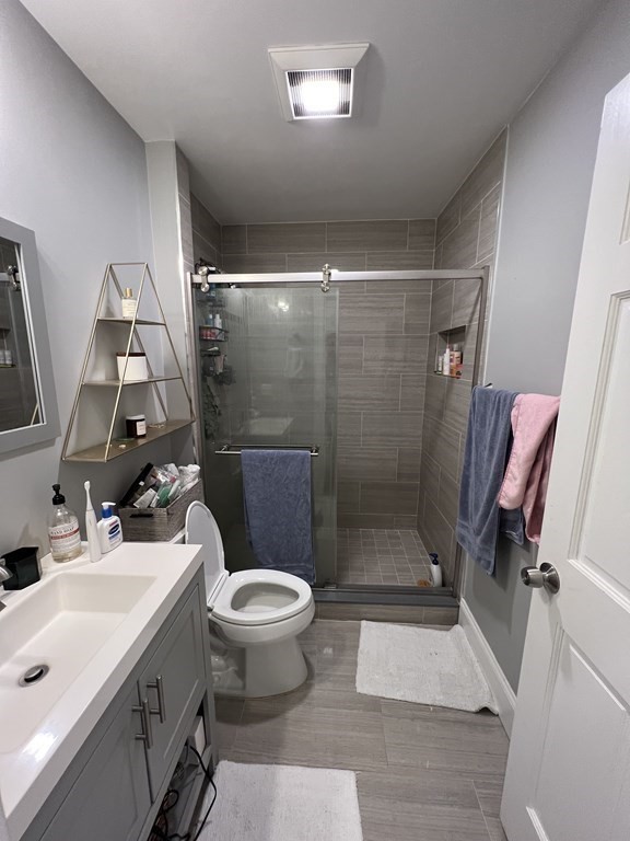 209 East Cottage Street, Unit 1 Boston, MA 02125 - Photo 6 of 10 a bathroom with a sink toilet and shower