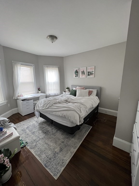 209 East Cottage Street, Unit 1 Boston, MA 02125 - Photo 7 of 10 a bedroom with a bed and window