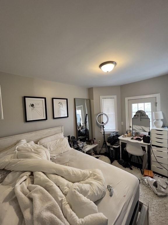 209 East Cottage Street, Unit 1 Boston, MA 02125 - Photo 8 of 10 a bed room with furniture and a window